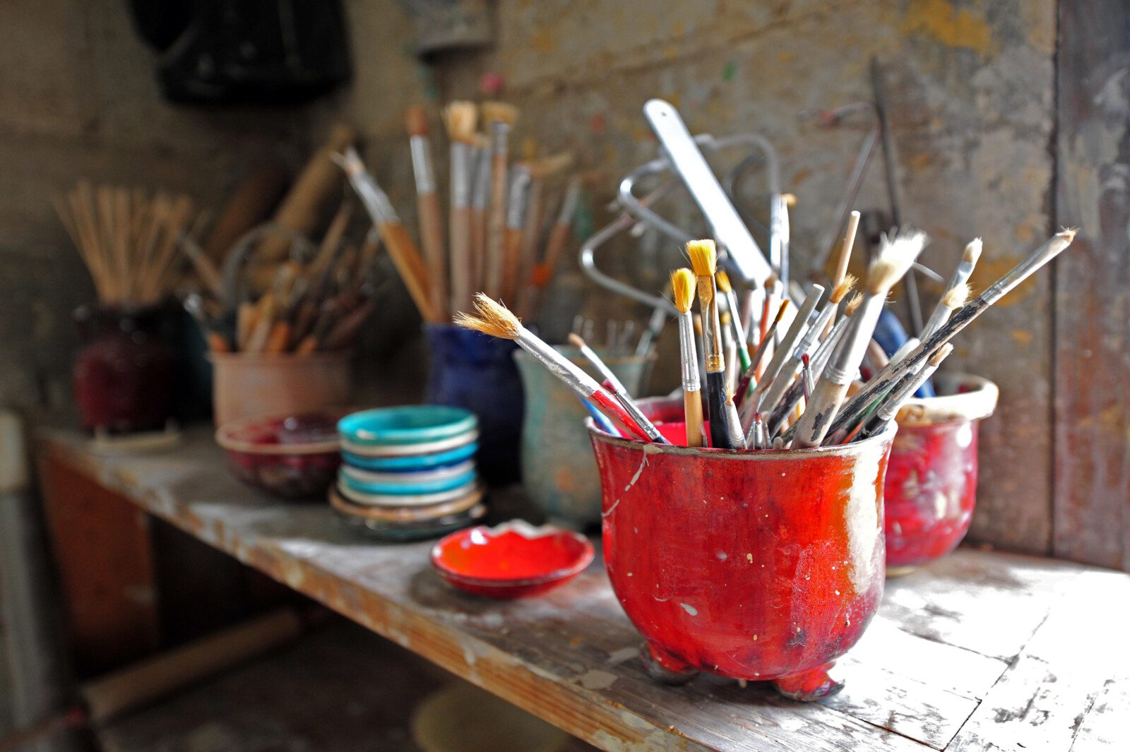 Large group of brushes in art studio. Creativity concept. No people. Copy space